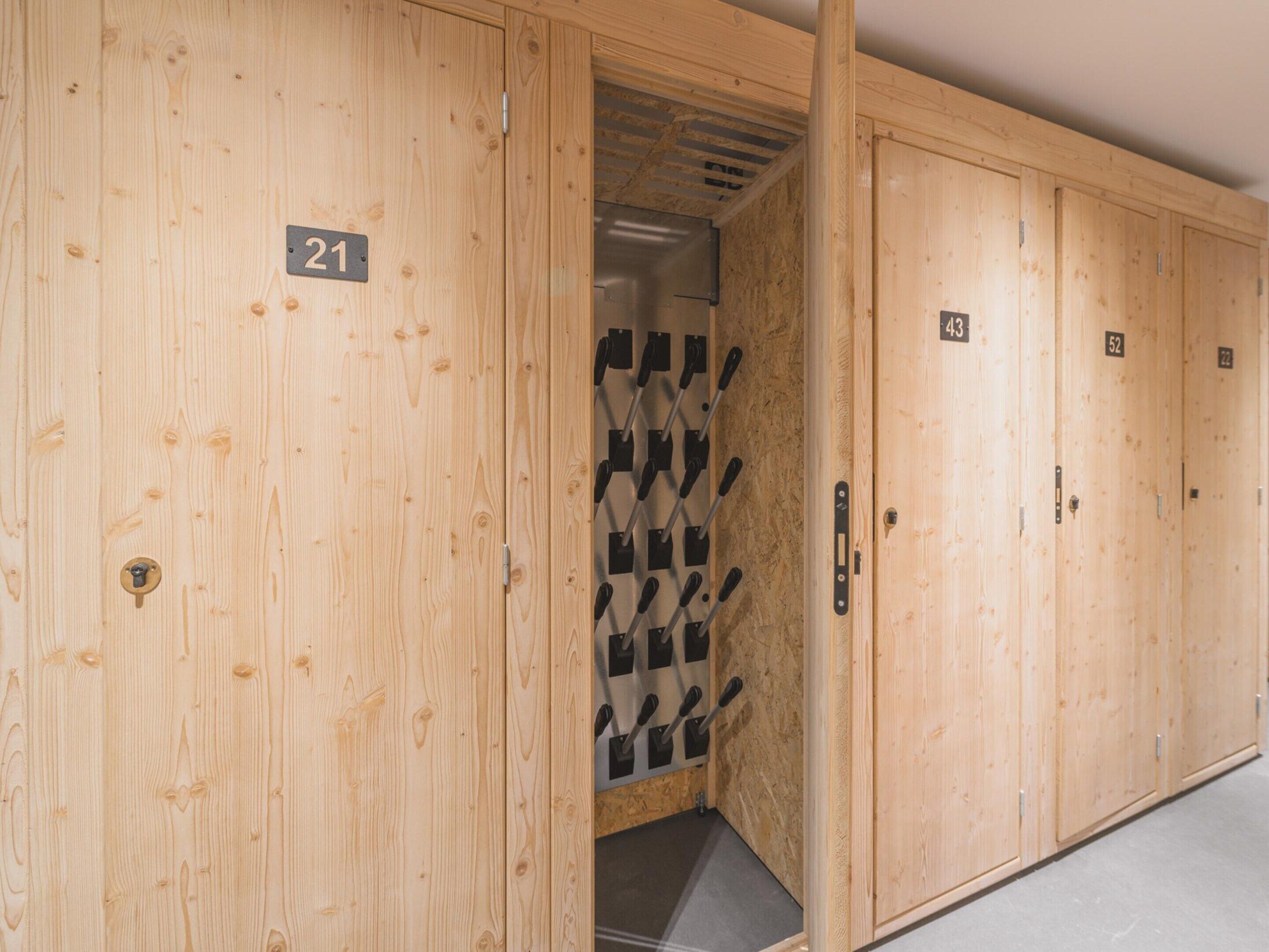 A row of wooden lockers numbered 21, 43, 52, and 22.