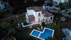 A two-story house with a tiled roof, a swimming pool, and a patio area. - Villa Birkin by Vacation Marbella (Nueva Andalucía)