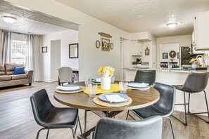 A dining area with a round table set for four, surrounded by black chairs. - 9 Mi to Dtwn Indianapolis: Family-Friendly Home! (Indianapolis)