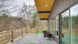 A covered outdoor area with stone flooring, wooden railings, and a seating area with chairs and a table. - 2 Mi to Hoosic River: 'The Moss House' w/ Deck! (Eagle Bridge)