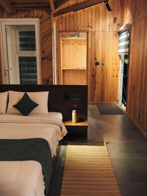 A bedroom with a bed, bedside table, and a wooden wardrobe. - Himkosi Farm by the River (Almora)