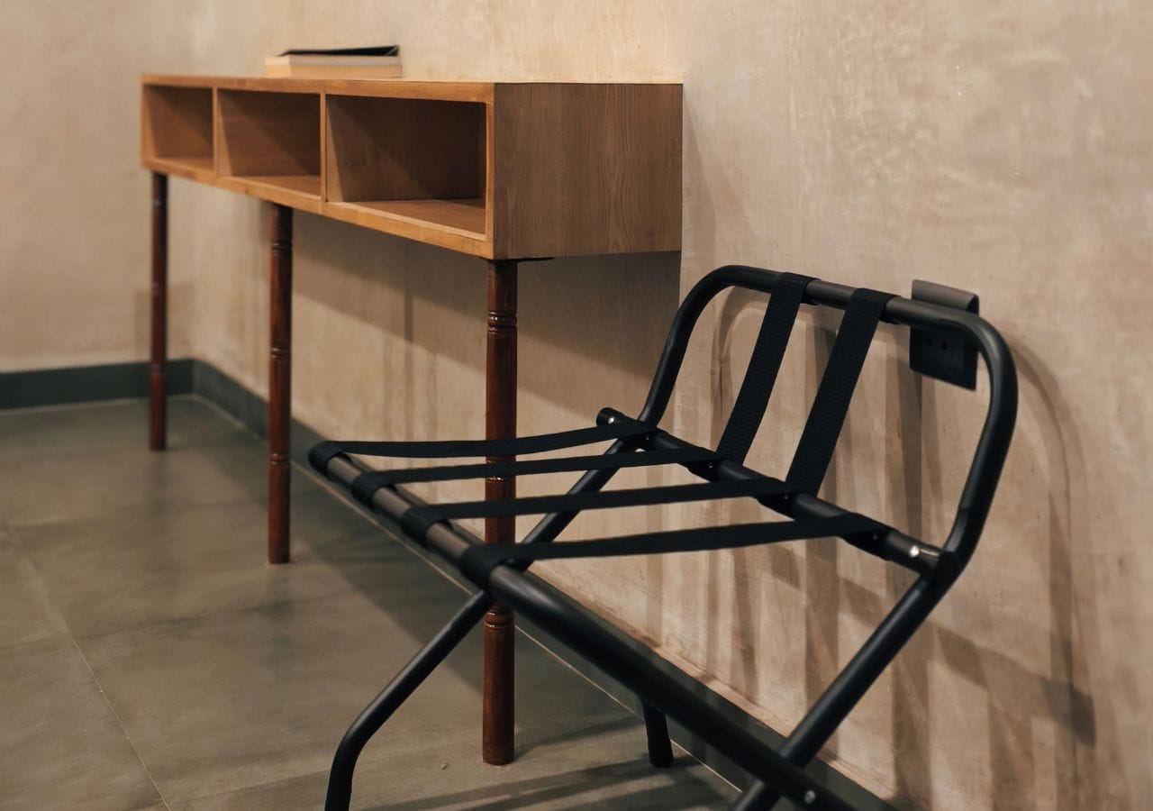 A black metal chair with a wooden table in the background.