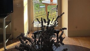 A room with a large window, a small table with chairs, and a potted plant. - Merula. Organic winery farm between Orvieto and Lake Bolsena (orvieto)