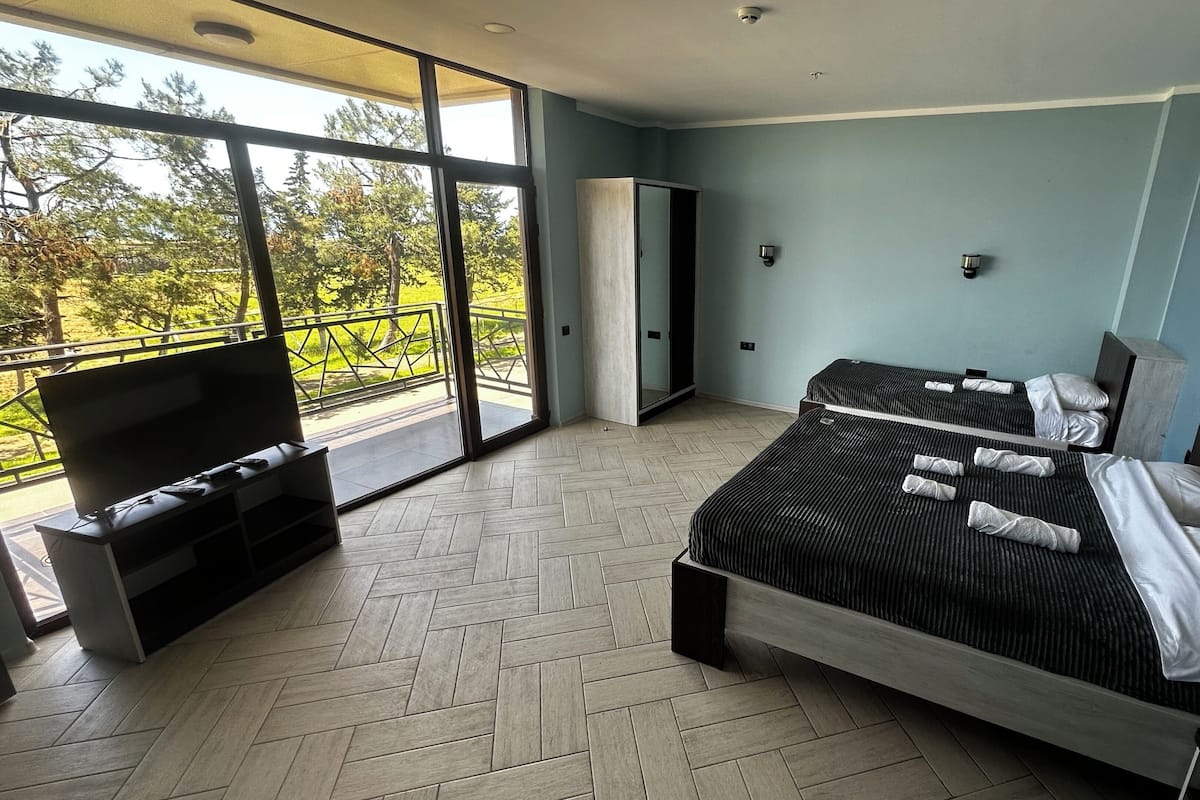Deluxe Triple Room, Sea View | In-room safe, desk, iron/ironing board, rollaway beds