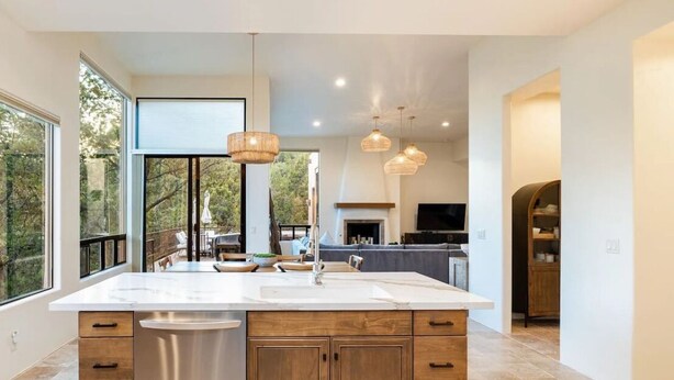 A spacious kitchen with a large island, stainless steel appliances, and pendant lighting. - Enchanted Waters Retreat (Sedona)