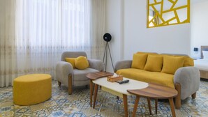 A modern living room with a sofa, armchairs, a coffee table, and a floor lamp. - Yelloscape/ Gemmayze (Beirut)