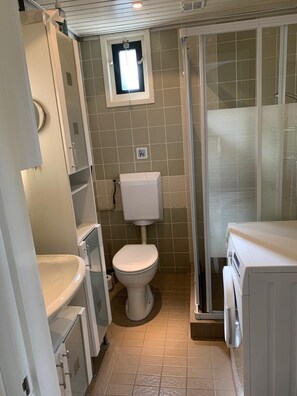 Shower, hair dryer, soap, toilet paper