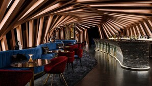 A modern interior with a curved ceiling, seating area, and bar. - The Vinyl Abode | Free Parking + 5-Minute CBD Walk (West Melbourne)