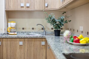 Microwave, dishwasher, coffee/tea maker, cookware/dishes/utensils