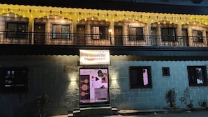A two-story building with a sign for 'Anandvan Beach Resort'. - Anandvan (Nagaon)