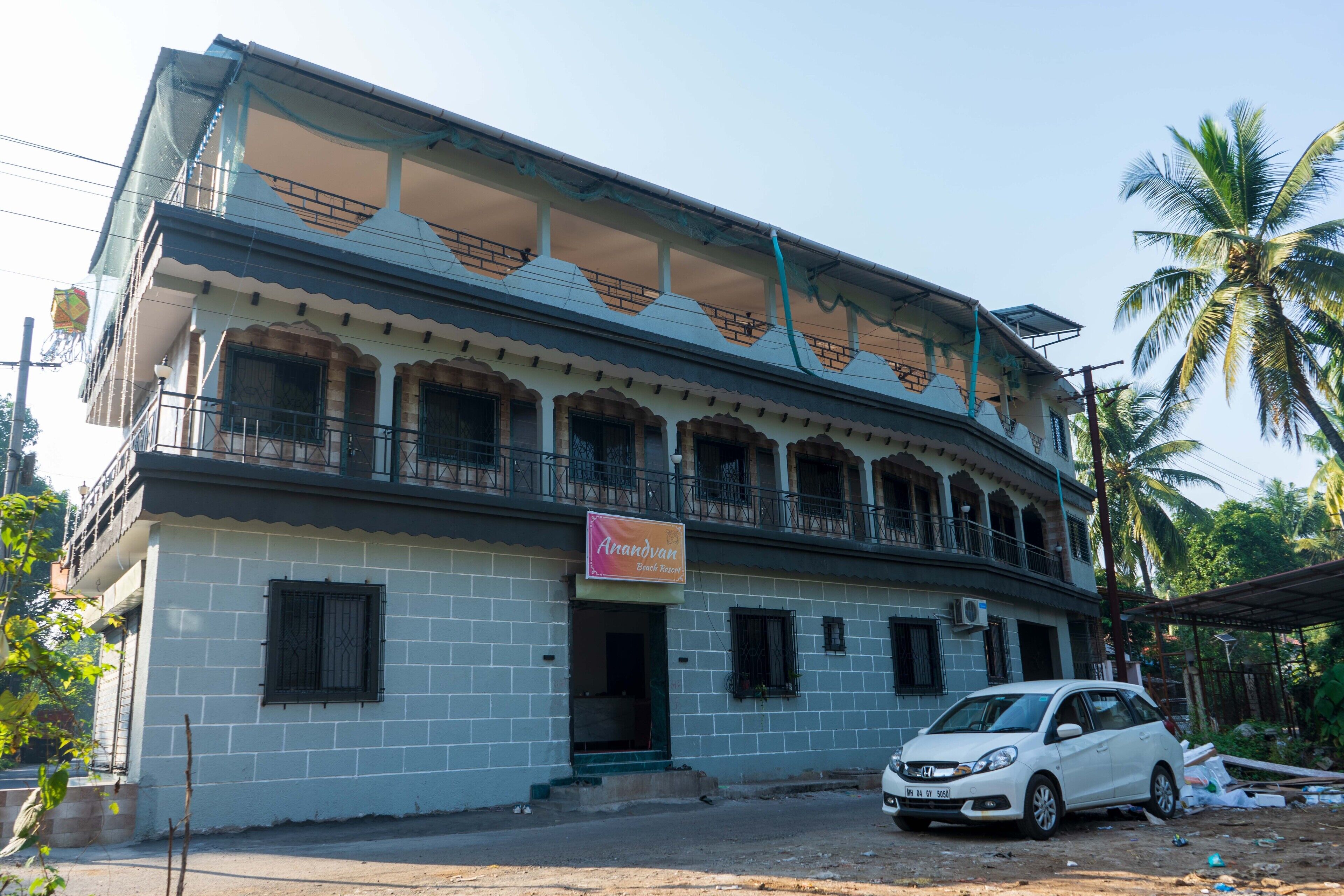 A two-story building with a sign reading "Arandyan Beach Resort."