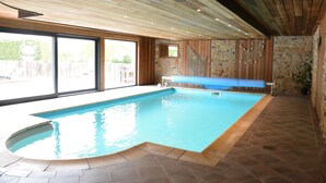 An indoor swimming pool with a wooden ceiling and stone walls. - Villa in Coo Near Waterfalls With Pool (Stavelot)