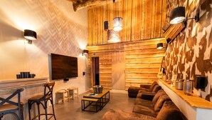 A cozy living room with a sofa, chairs, a coffee table, and a TV. - Villa in Coo With Indoor Pool & Near Waterfalls (Stavelot)