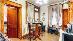 A dining area with a wooden table and chairs, a kitchen area with a sink and cabinets, and a sign that reads "Family". - 2 Mi to Dtwn: Harrisburg Escape w/ Furnished Deck! (Harrisburg)