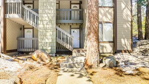 A two-story building with a central staircase, a large tree in front, and a snow-covered ground. - Walk to Shops & Eats: Mammoth Lakes Condo w/ Pool (Mammoth Lakes)