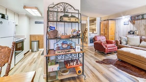 A spacious living room with a red leather sofa, a wooden coffee table, and a large rug. There is a kitchen area with white cabinets and a refrigerator. - Walk to Shops & Eats: Mammoth Lakes Condo w/ Pool (Mammoth Lakes)