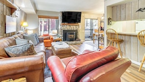 A cozy living room with leather sofas, a fireplace, and a television. - Walk to Shops & Eats: Mammoth Lakes Condo w/ Pool (Mammoth Lakes)
