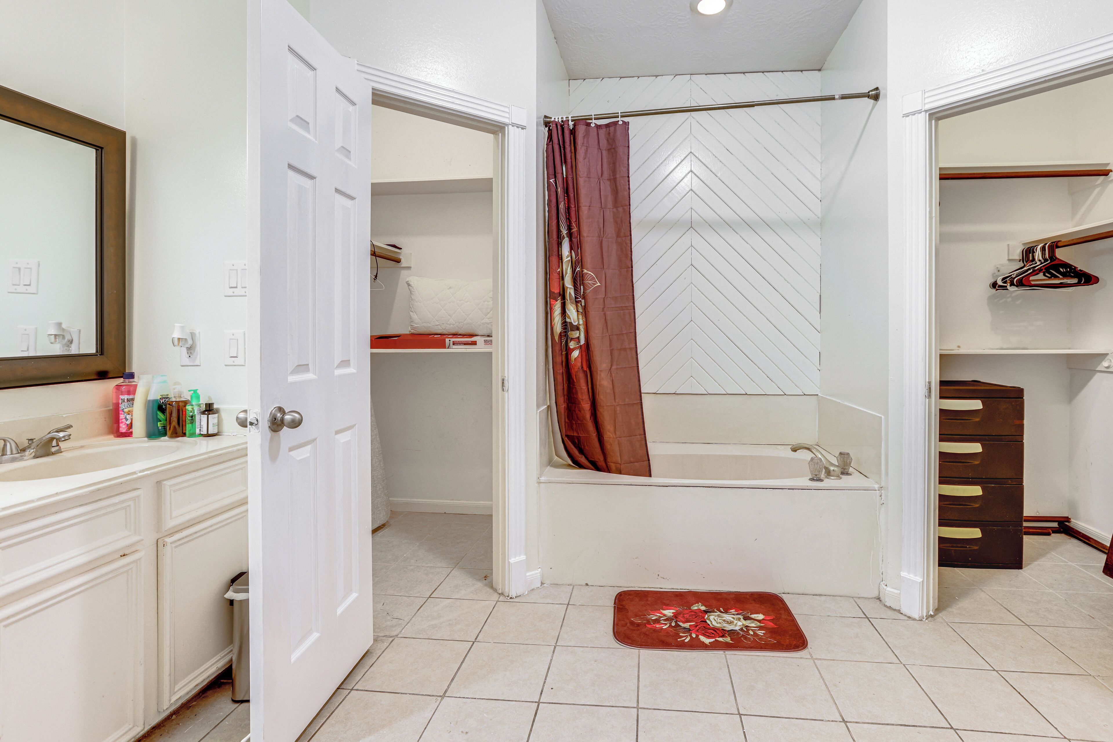A bathroom with a shower, toilet, and sink.