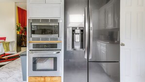 A kitchen with a built-in microwave, oven, and refrigerator. - Home 7 Mi to Energy Corridor: Remote-work Ready! (Houston)