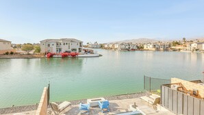 A residential area with a swimming pool, houses, and a clear sky.
