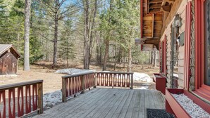 A wooden deck with a red railing, surrounded by a forested area. - 2 Mi to Ossipee Lake: Forest-view Sanctuary! (Freedom)