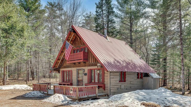 A log cabin with a metal roof, wooden deck, and a small porch. - 2 Mi to Ossipee Lake: Forest-view Sanctuary! (Freedom)