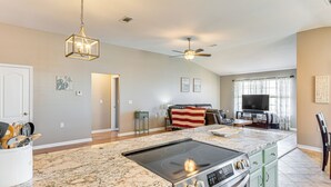 A kitchen with granite countertops, a stove, and a ceiling fan. - Outdoor Entertaining Space: Family Home in Milton (Milton)