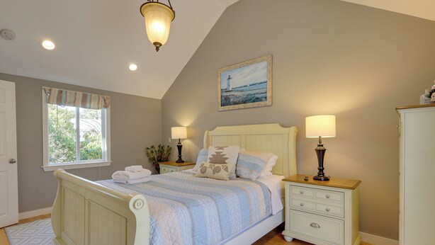 A bedroom with a bed, nightstands, a dresser, and a window with curtains. - 1 Mi to South Village Beach: Bbq-ready Retreat (West Dennis)