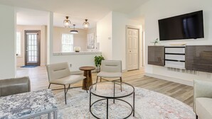 A spacious living room with a large TV, comfortable seating, and a modern design. - < 1 Mi to Main St & Amphitheater: Woodstock Home! (Woodstock)