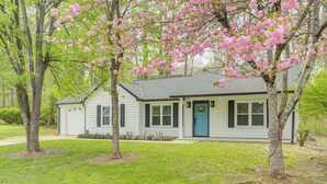 A single-story house with a front porch, a blue door, and a small front yard. - < 1 Mi to Main St & Amphitheater: Woodstock Home! (Woodstock)
