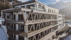 A modern building with multiple balconies and large windows, set against a mountainous backdrop. - Apartment in Plan Peisey Near Vanoise Park (Peisey-Nancroix)