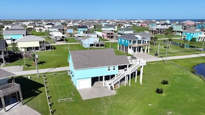 A coastal residential area with houses featuring balconies and waterfront views.