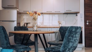 A modern kitchen with white cabinets, a wooden table, and four upholstered chairs. - Luxury Lake Nearby Free Parking Pet Friendly APT (Ohrid)