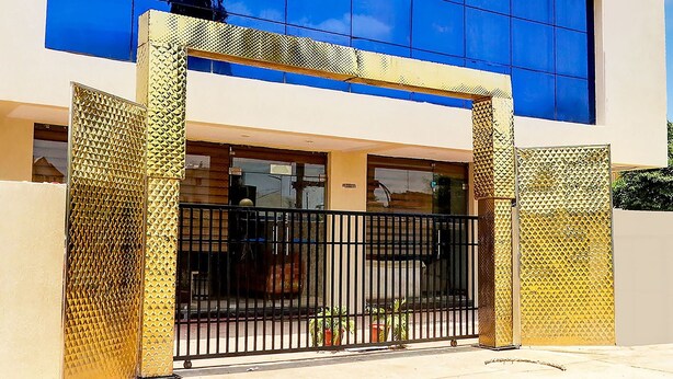 A building with a modern facade, large windows, and a gated entrance.