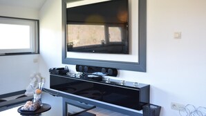 A modern kitchen with a built-in oven and microwave, a large window, and a decorative vase on the counter. - Lake-view Apartment With Sauna, hot tub (Stavelot)