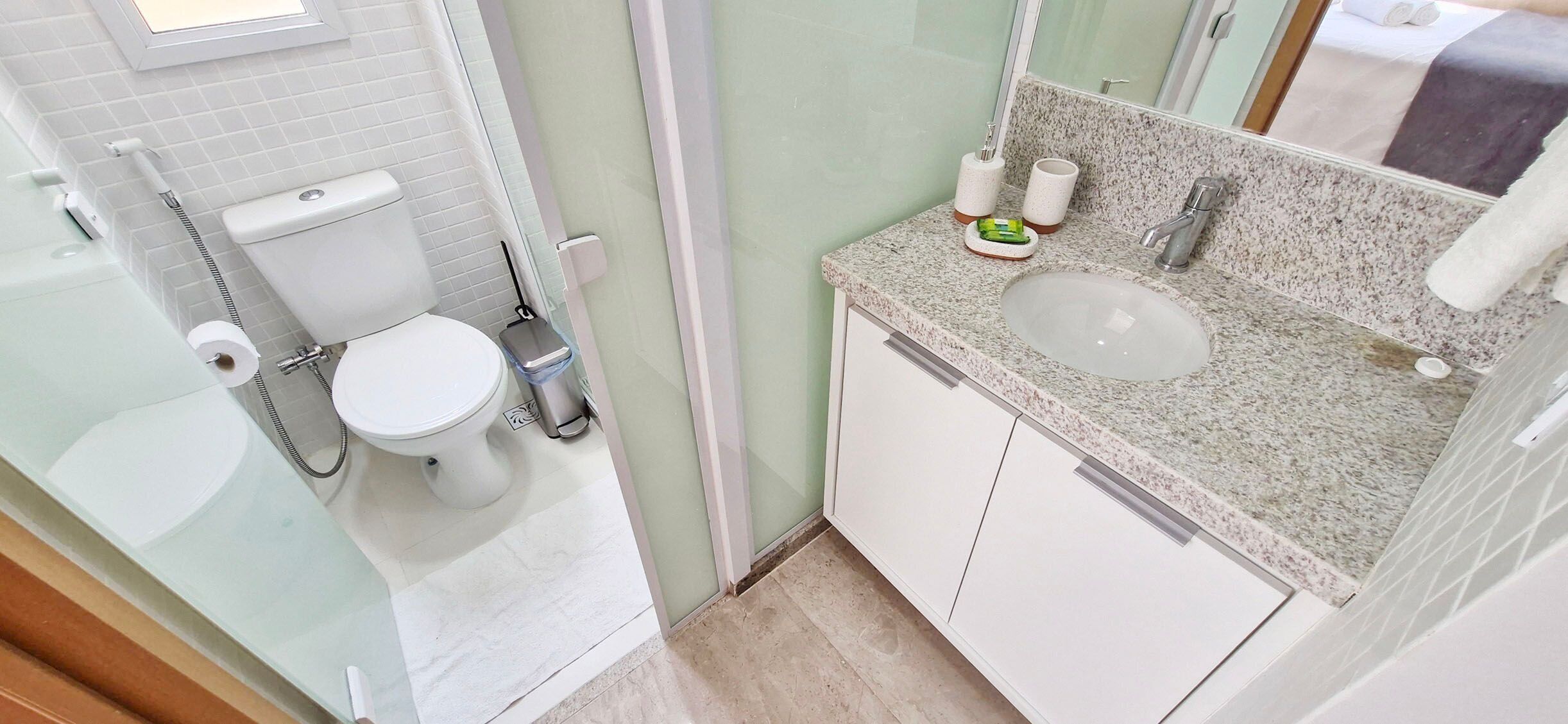 A modern bathroom with a toilet, bidet, and sink.