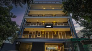 A multi-story hotel with a sign indicating 'TOWNHOUSE OAK' and 'Company Service.' - Classic Cloud Bay (Gurugram)