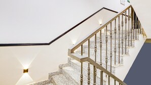 A staircase with a marble finish and a metal railing. - Classic Cloud Bay (Gurugram)