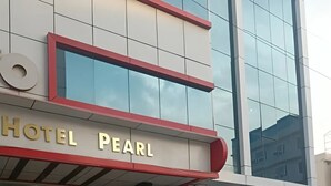 A modern hotel building with a prominent sign reading "HOTEL PEARL". - Hotel Pearl (Haridwar)