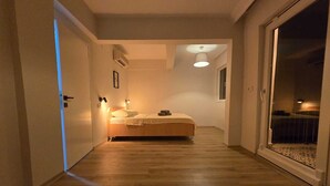 A narrow hallway leading to a bedroom with a bed, a ceiling fan, and a window. - VILLA OLINDA 4 BED with huge garden (Serik)