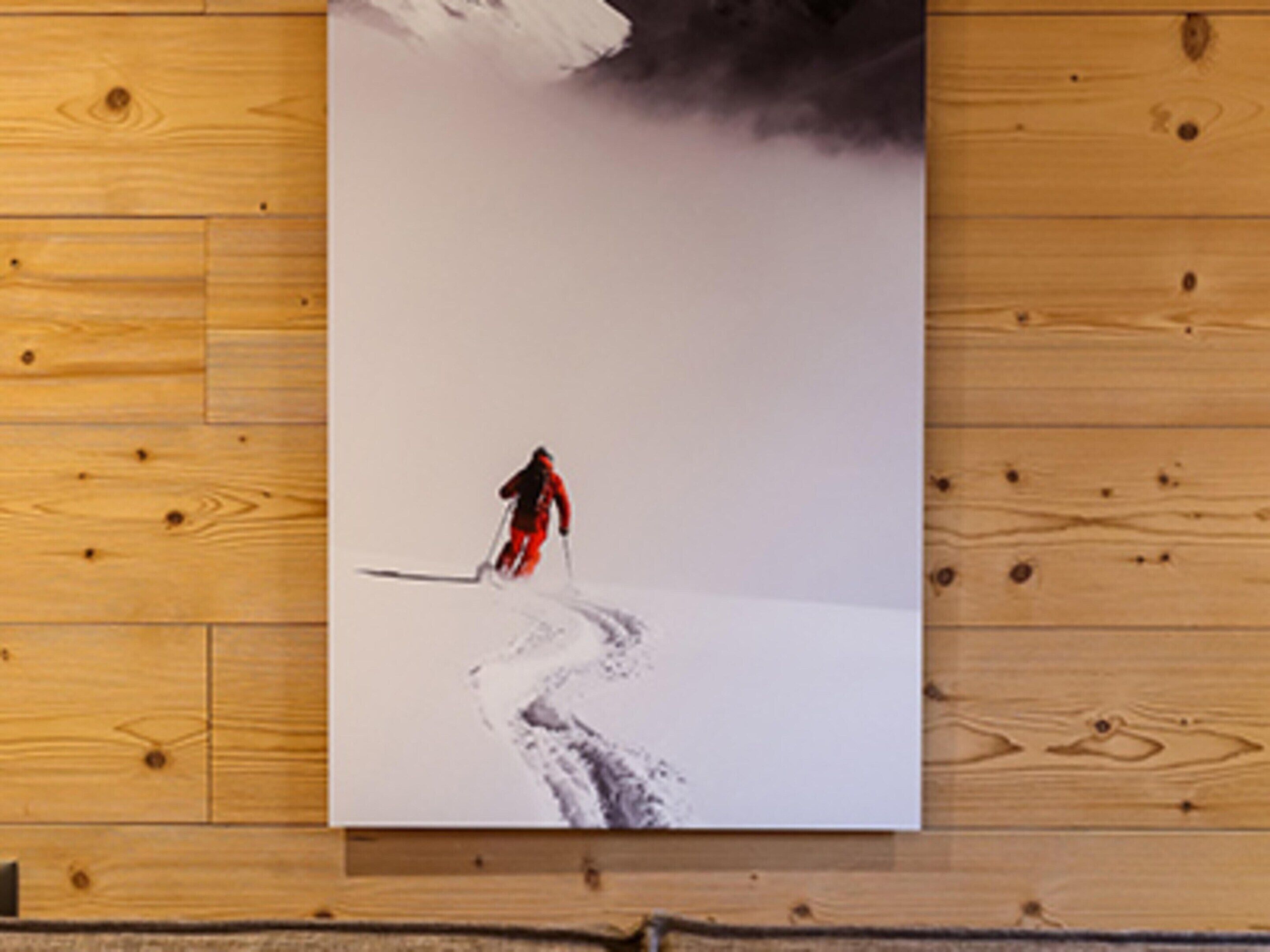A photograph of a person skiing on a snowy path.