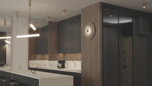 Una cocina moderna con una isla central, taburetes de bar e iluminación colgante.