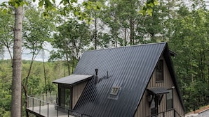 A cabin with a sloped roof, a deck, and a gravel driveway. - Riverfront A-Frame Cabin in the Mountains w/ Sauna & Private Hiking Trail (Ellijay)