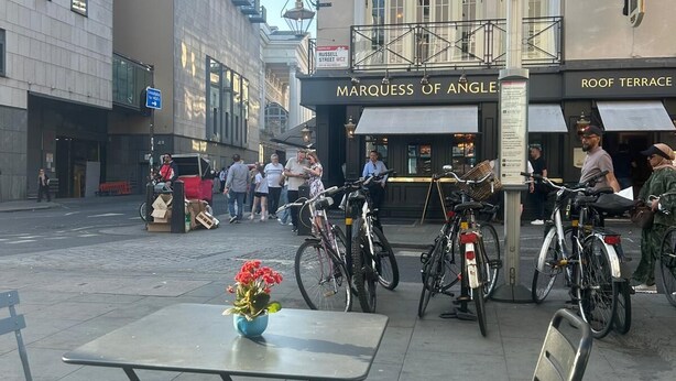 A street with outdoor seating, bicycles, and a building with a sign reading "MARQUESS OF ANGLES". - Large 3 bedroom apartment in Heart of Theatre District (London)