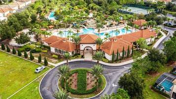 A residential area with a central circular driveway, a swimming pool, and a tennis court.