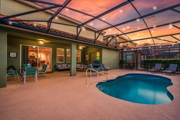 An indoor pool area with a clear view of the pool, lounge chairs, and a covered patio. - 5BR Family Home with Private Pool Solterra Resort (Davenport)