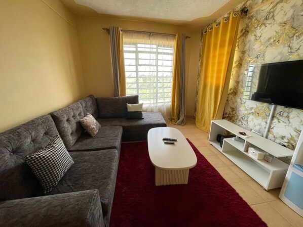 Classic Apartment, City View | Living area | 24-inch Smart TV with digital channels - Nila Apartments Utawala (Nairobi)