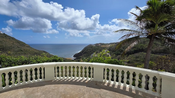 A balcony with a view of the ocean and hills. - 5 Bedroom, luxury private villa with pool & 360' ocean views (Gros Islet)