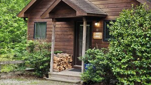A wooden lodge with a sloped roof, a front porch, and a sign indicating it is number 10. - Perfect Honeymoon cabin w/hot tub (Asheville)