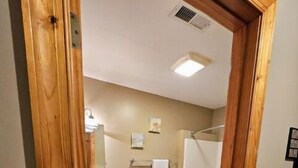 A bathroom with a toilet, sink, and shower. - Perfect Honeymoon cabin w/hot tub (Asheville)